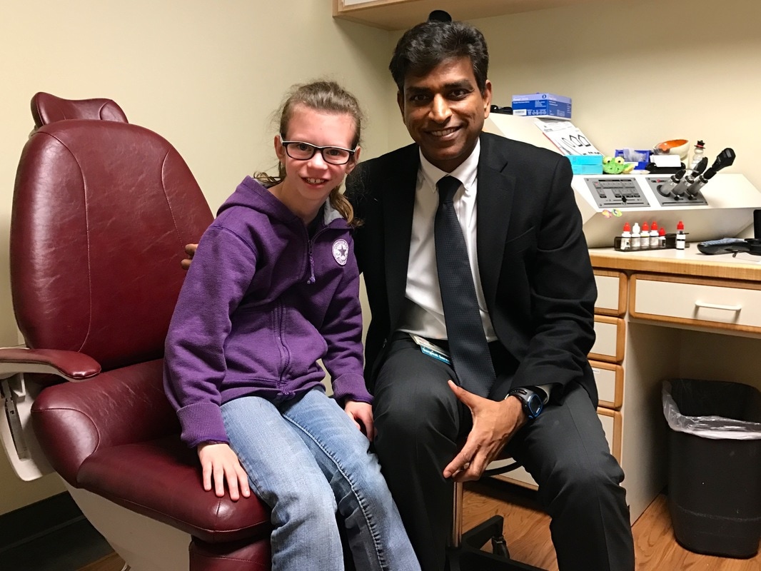 Visually impaired girl with eye doctor