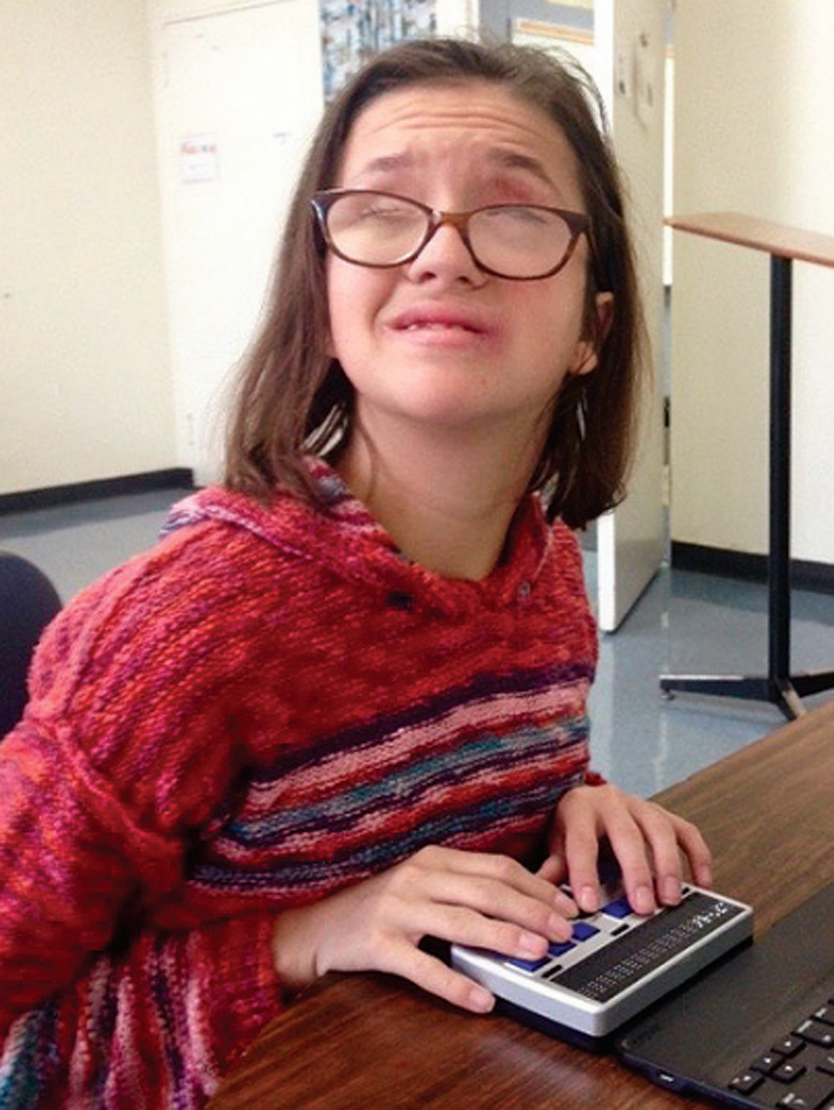 Visually impaired girl uses brailler